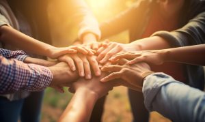 portrays a diverse group of volunteers joining hands in unity